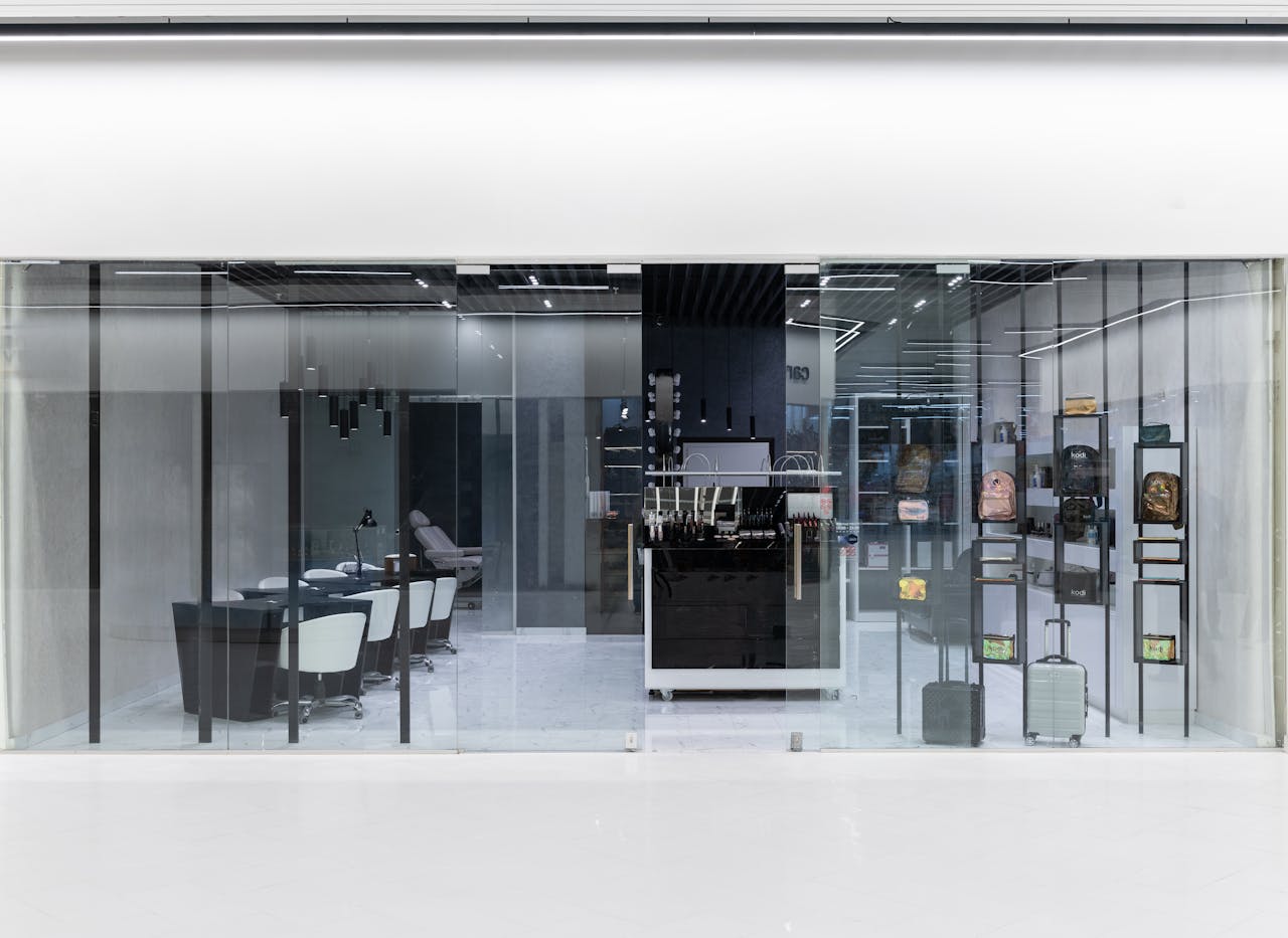 Sleek interior of a modern store with glass facade, stylish furniture, and display items.
