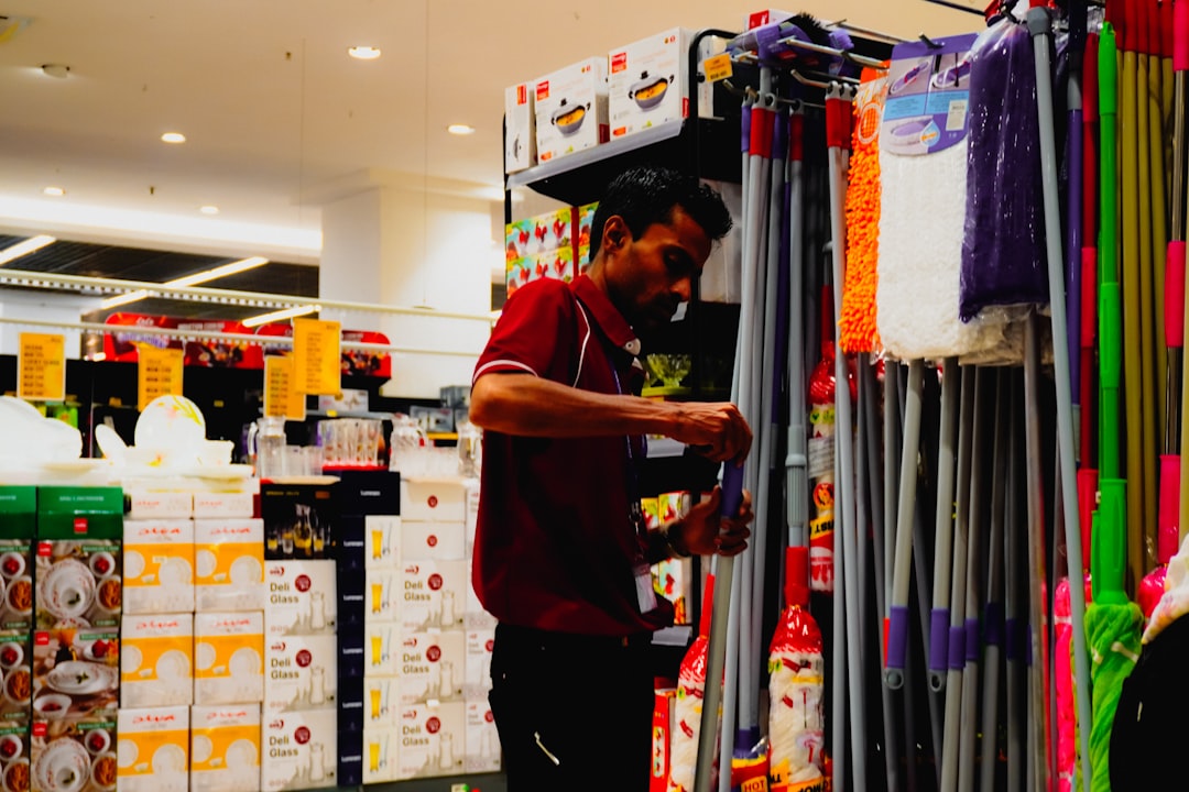 man-arranging-cleaning-supplies-in-a-store-v-isgw3g-de